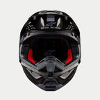 Alpinestars Supertech M10 Solid Helmet, Motocross Helmet, Black Glossy Carbon, front view showing red interior lining, carbon fiber shell, and "ONE GOAL. ONE VISION." slogan on the visor area