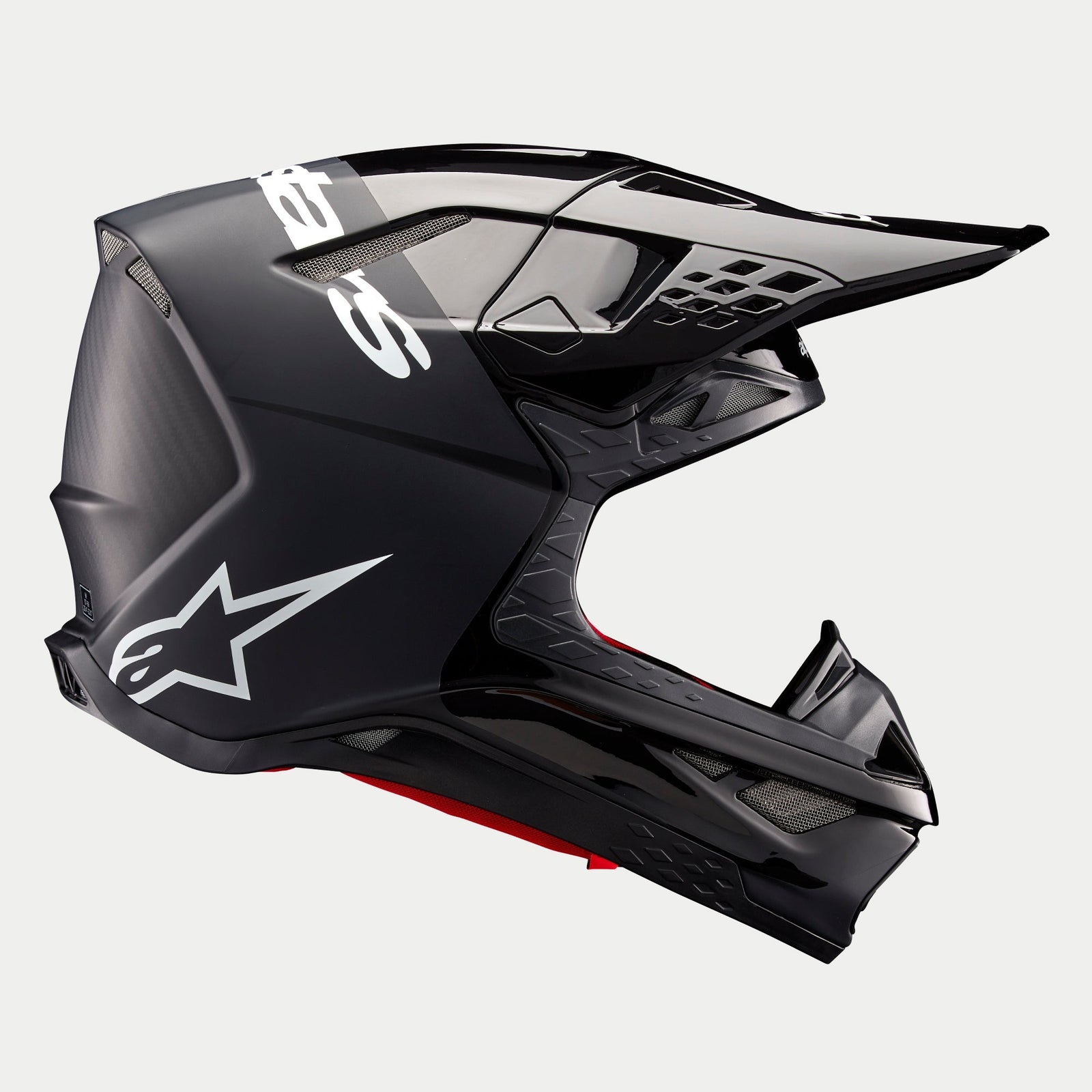 Alpinestars Supertech M10 Flood Helmet ECE, Motocross Helmet, Black and Dark Gray with Matte and Glossy finish, side profile view featuring aerodynamic design, integrated visor, and white Alpinestars branding