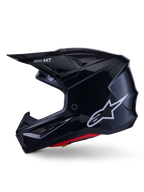 Alpinestars S-M7 Solid Helmet, Glossy Black Motocross Helmet, side profile showing white Alpinestars logo, aerodynamic shell with ventilation mesh and red interior padding, advanced off-road protection