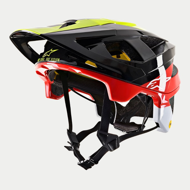 The Vector Tech Pilot Helmet CE, crafted by Alpinestars EU, boasts a sleek multicolored design featuring black, yellow fluo, and red glossy sections. The helmet is designed with ventilation openings and an adjustable strap system to ensure rider protection. Enhanced safety is provided through MIPS technology, while the brand name "Alpinestars" is prominently displayed on the side. The background is white.