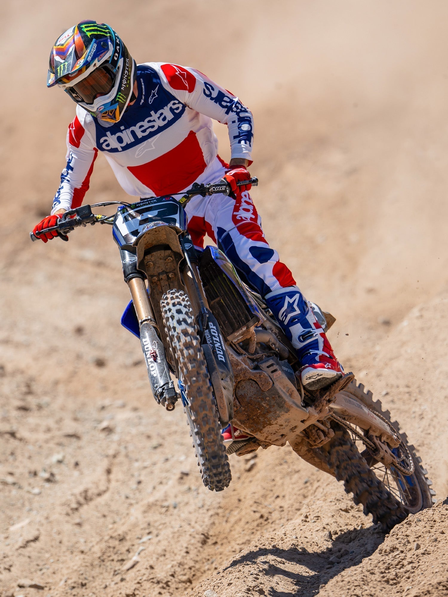 Alpinestars Limited Edition Techstar Fortitude Pants, Motocross Pants, Bright Red White and Blue, worn by a rider in action on a dirt track, featuring matching jersey and boots, performance-driven off-road racing gear.