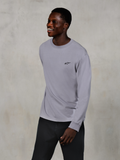Alpinestars Essentials Ageless LS Tee, Long Sleeve T-Shirt, Silver, small black logo on the chest, worn by a smiling model with dark pants, relaxed contemporary fit, casual motorsport lifestyle apparel
