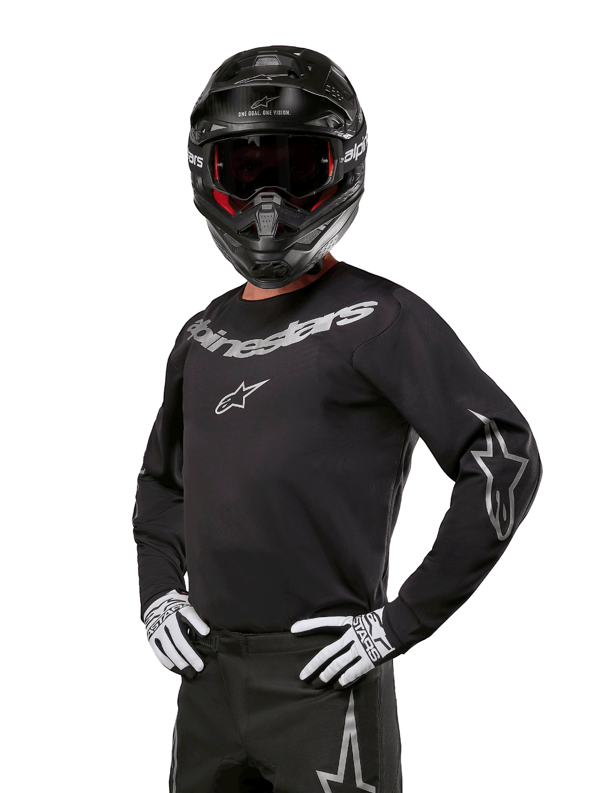 Alpinestars 2024 Fluid Graphite Jersey, Black and Silver Motocross Jersey, long-sleeve performance fit, worn with a black helmet and white gloves, featuring silver Alpinestars branding, off-road racing gear