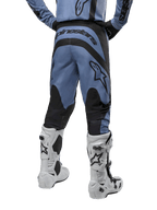 Alpinestars 2024 Fluid Lurv Pants, Motocross Pants, Light Blue and Black, back view showing black reinforced panels and large brand logo, paired with white and black motocross boots, professional racing gear for off-road riding