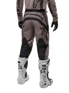 Alpinestars 2024 Fluid Lurv Pants, Motocross Pants, Mud Black, back view showing large black Alpinestars logo on the seat and black calf panels, worn with white and black motocross boots and matching jersey.