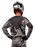 Alpinestars 2024 Racer Tactical Jersey, Motocross Jersey, Cast Gray Camo Magnet, back view showing gray and black camouflage pattern, worn with matching pants and a black and white helmet, professional off-road racing gear