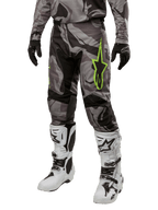 Alpinestars 2024 Racer Tactical Pants, Motocross Pants, Gray and Black Camouflage, lime green star logo, worn with white and black boots and black gloves, off-road riding gear