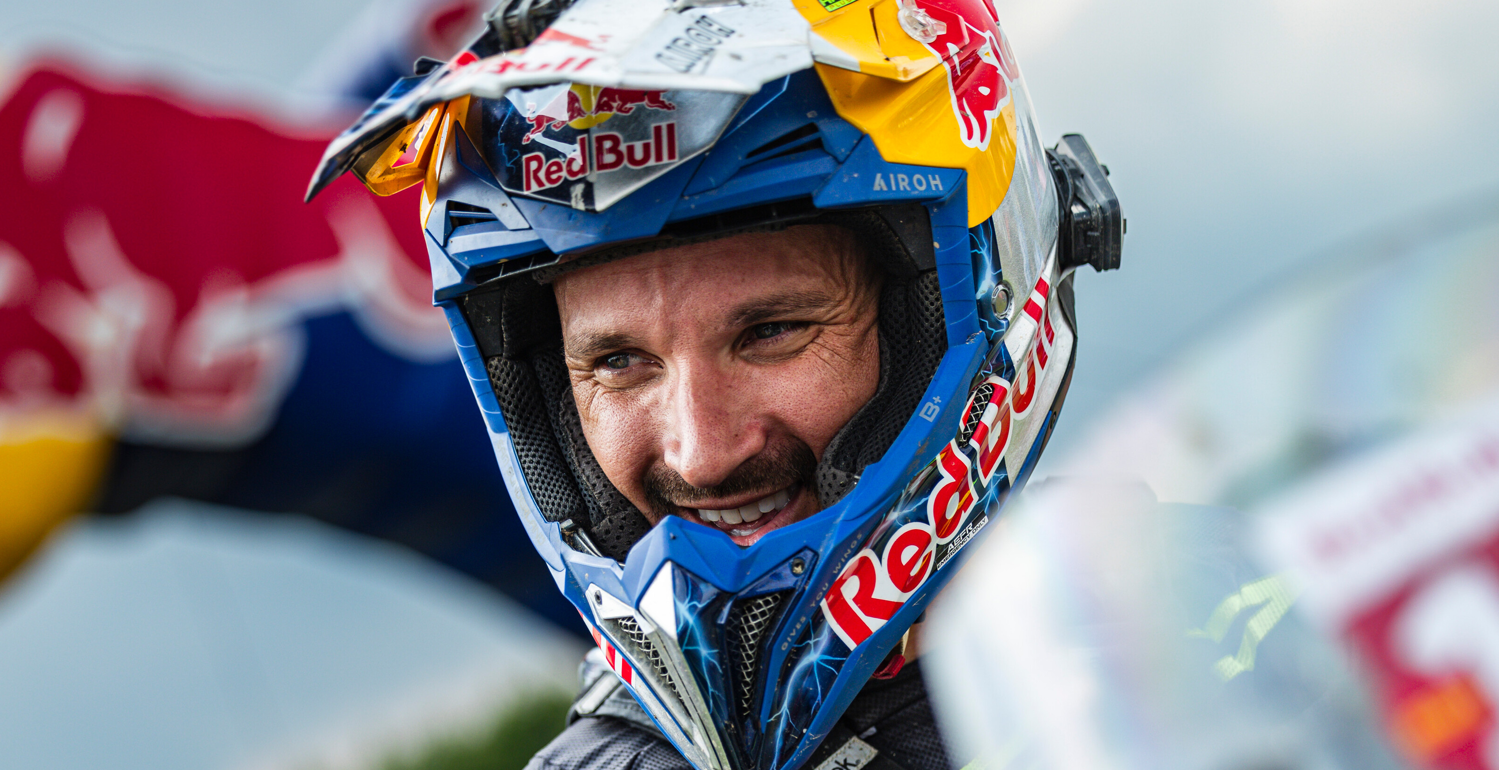 Sam Sunderland wearing a Red Bull branded helmet with a blurred background