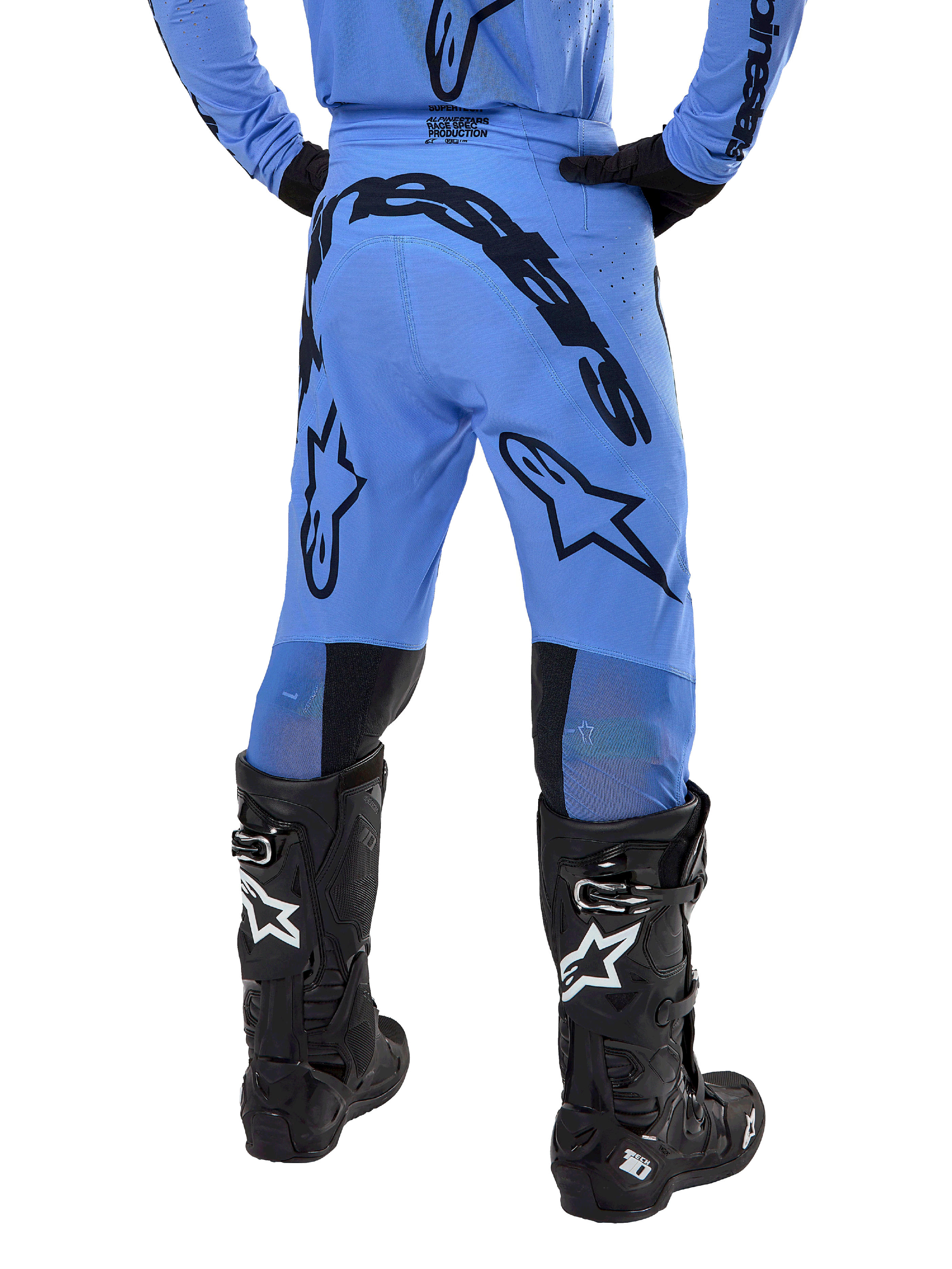 Alpinestars 2024 Supertech Dade Pants, Motocross Pants, Light Blue, rear view showing large black branding on the seat and legs, worn with black Alpinestars Tech 10 boots, athletic race fit for professional off-road performance.