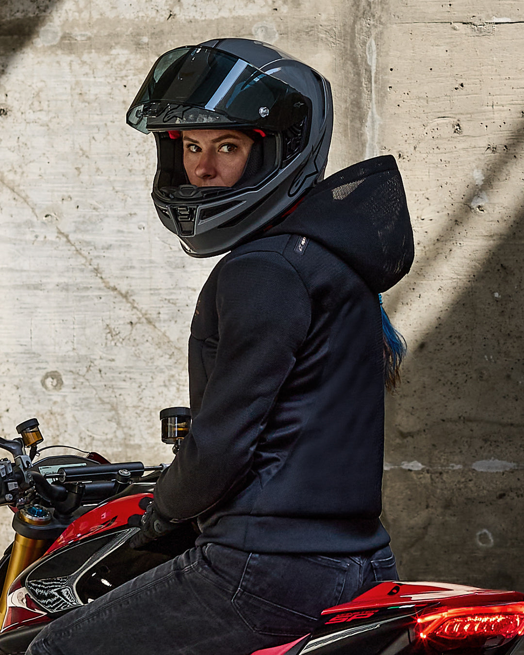 Alpinestars Stella Chrome Superairflow Hoodie, women's black 3D mesh motorcycle jacket, worn by rider on a red sport bike.