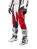 Alpinestars 2024 Techstar Ocuri Pants, Motocross Racing Pants, Mars Red White and Black, worn with matching white and black jersey, black gloves, and white racing boots with buckles, technical protective gear shown on a white background
