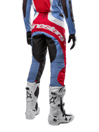 Alpinestars 2024 Techstar Ocuri Pants, Motocross Pants, Light Blue, Mars Red, and White, rear view highlighting the large red Alpinestars logo across the seat, worn with white racing boots and matching jersey.