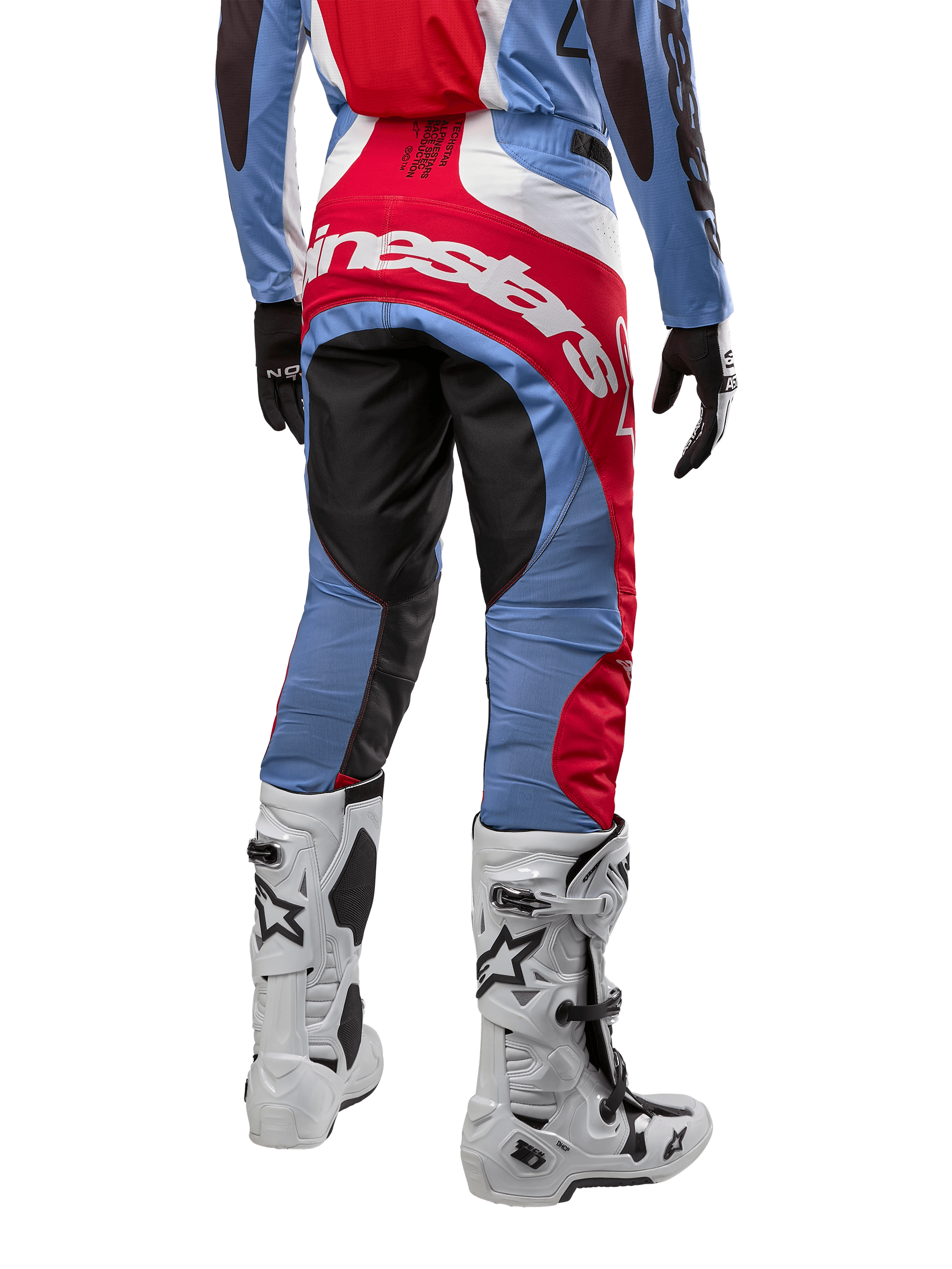 Alpinestars 2024 Techstar Ocuri Pants, Motocross Pants, Light Blue, Mars Red, and White, rear view highlighting the large red Alpinestars logo across the seat, worn with white racing boots and matching jersey.