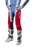Alpinestars 2024 Techstar Ocuri Pants, Motocross Pants, Light Blue, Mars Red and White, worn with light blue jersey and white boots, featuring the star logo on the thigh and reinforced knees, complete off-road racing gear