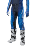 Alpinestars 2024 Techstar Pneuma Pants, Motocross Pants, Dark Navy and Light Blue, worn with matching blue jersey and white boots, featuring white logo on thigh, textured grip areas, sleek sporty design for off-road racing