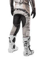 Alpinestars 2024 Techstar Pneuma Pants, Motocross Pants, Dark Sand and Iron Dust Gray, rear view from the waist down, bold black Alpinestars branding on the seat, worn with white and black motocross boots and black gloves, durable race-fit design for off-road competition