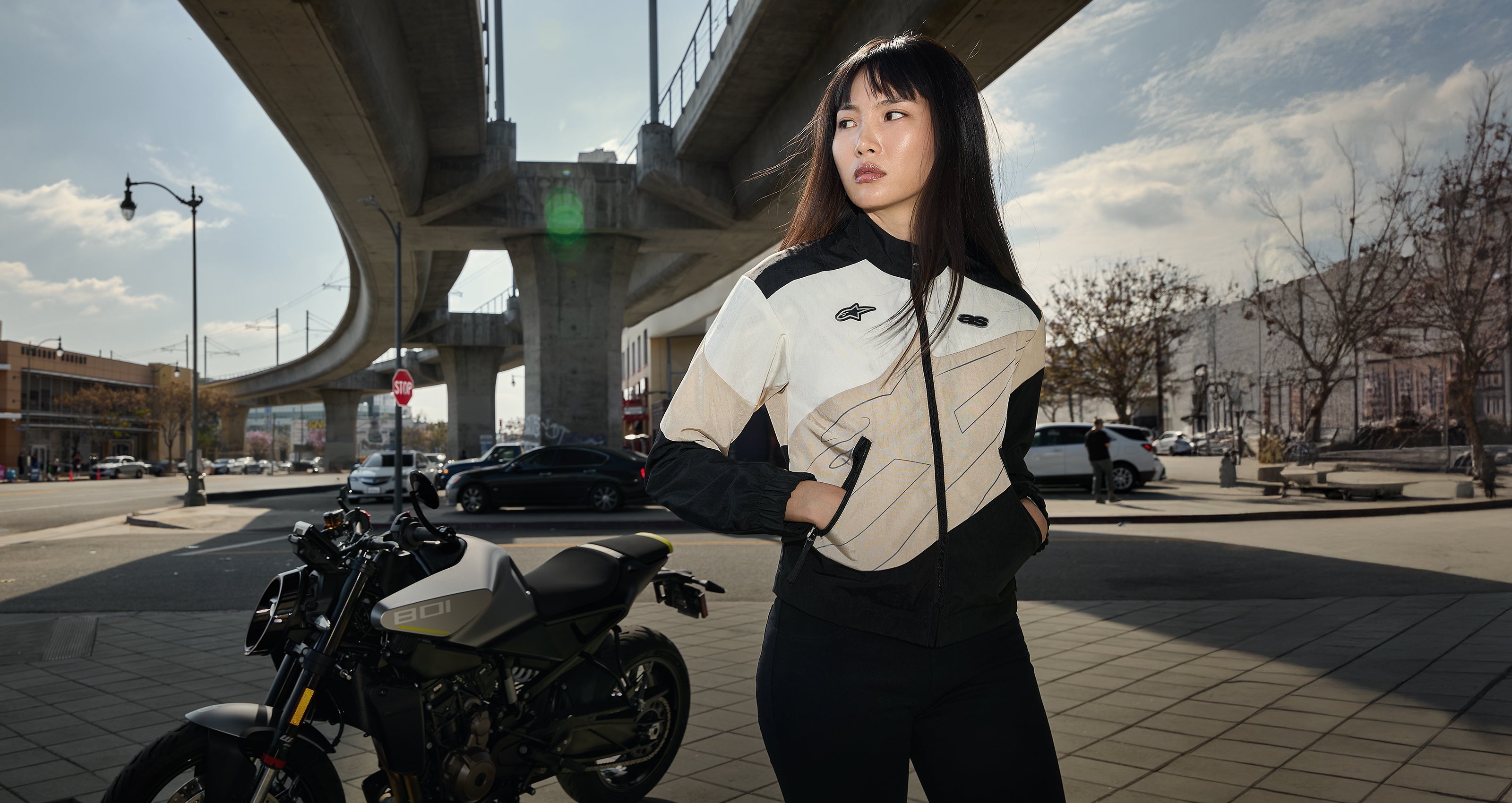 Alpinestars Women's Contemporary Urban Motorcycle Jacket in Black and Cream, styled for street riding in a city setting.