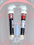 Alpinestars Tech-Air 7X & Off-Road Replacement Canister Kit, Airbag Replacement Canisters, Black with white tops and orange bands, dual argon canisters shown installed in a red and black honeycomb-patterned electronic airbag system with colored wiring